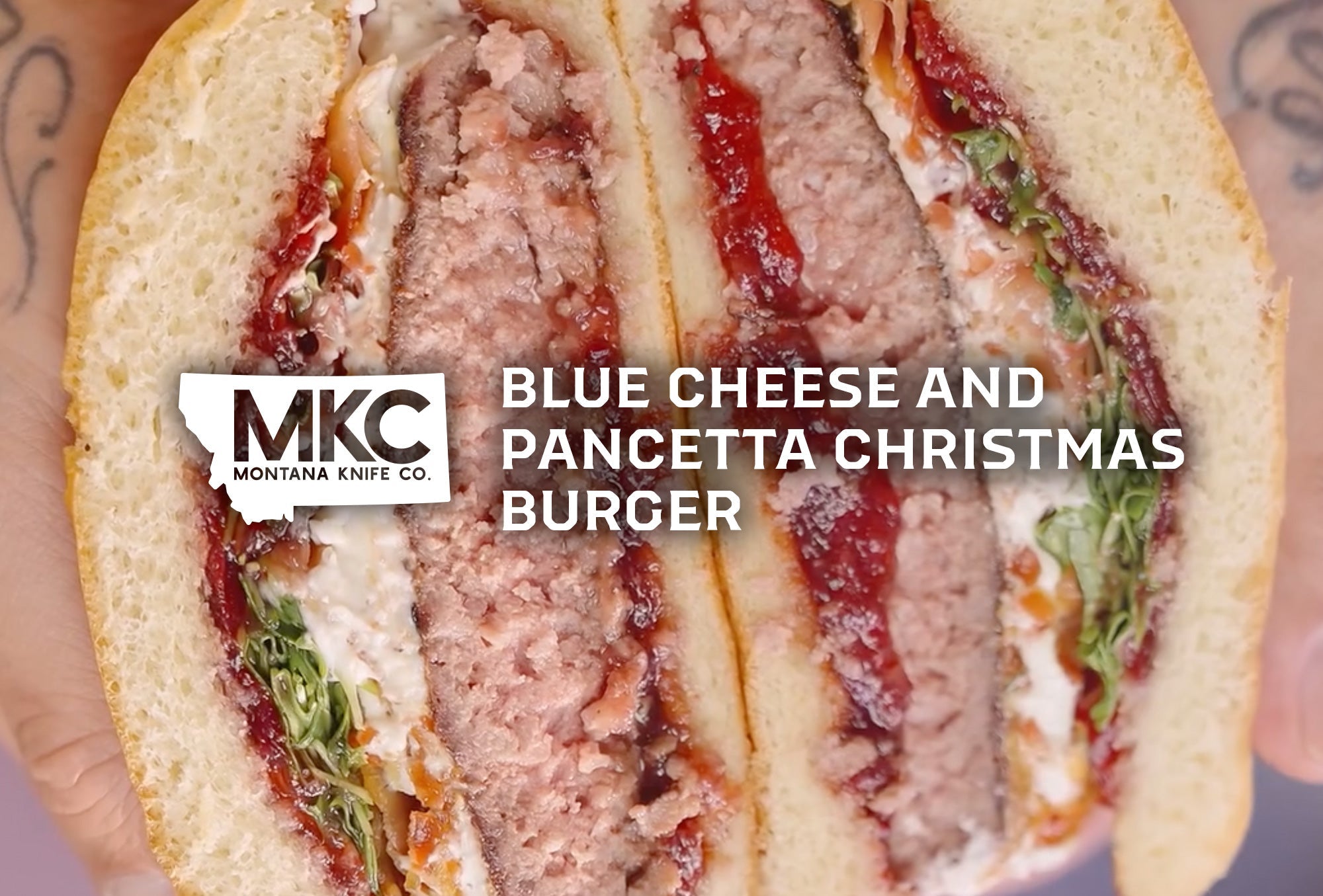 Christmas burger with beef patty, crispy pancetta, blue cheese dressing, cranberry sauce, and brioche bun.