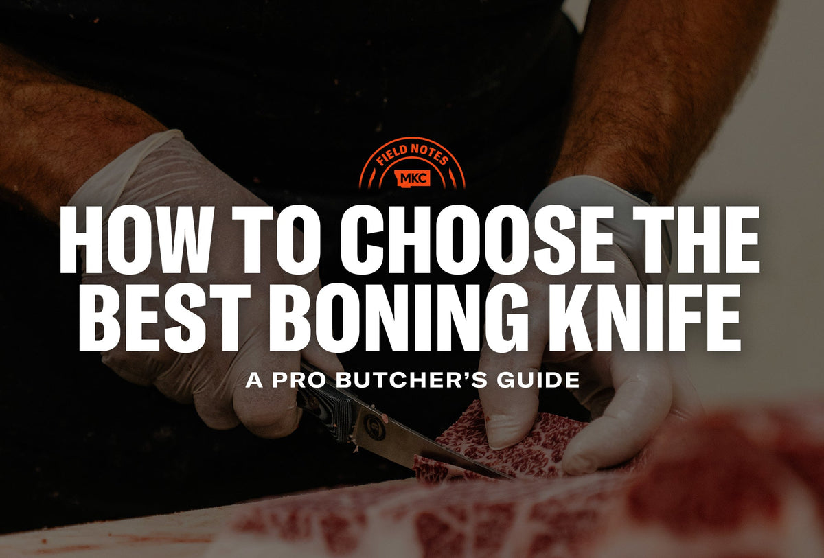 Gloved butcher slicing marbled meat with a boning knife on a dark background.