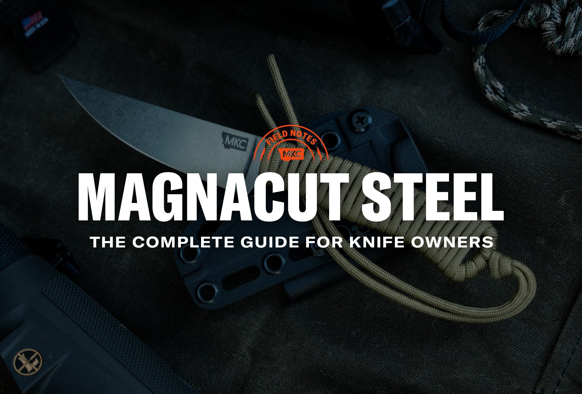 An MKC knife with a MagnaCut steel blade, sheath, and paracord resting on a dark surface.