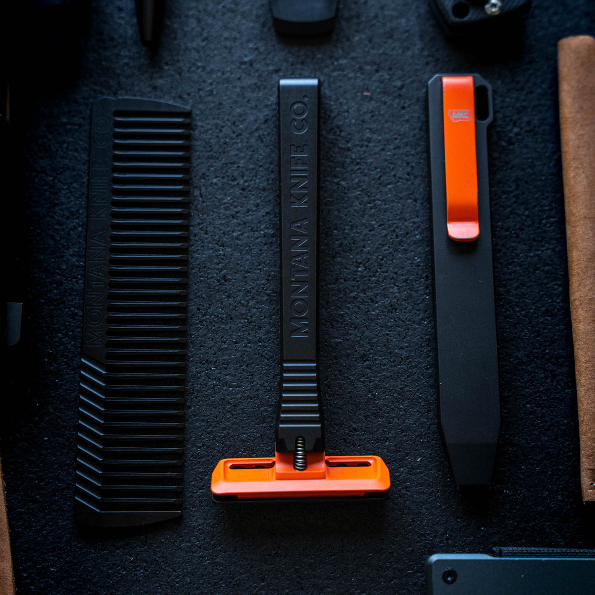 Montana Knife Company EDC Razor 2.0 in black and orange, designed for everyday carry and utility tasks.