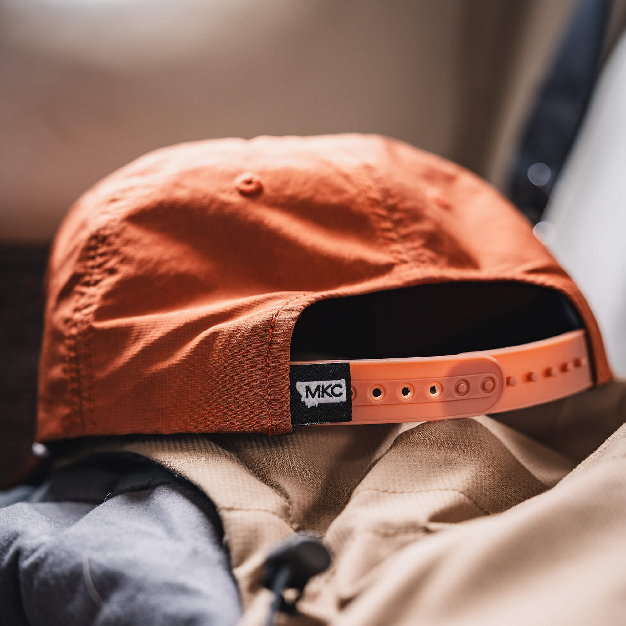 Rust-colored MKC River Rope Hat with adjustable strap, showcasing the Montana Knife Company logo on the back.
