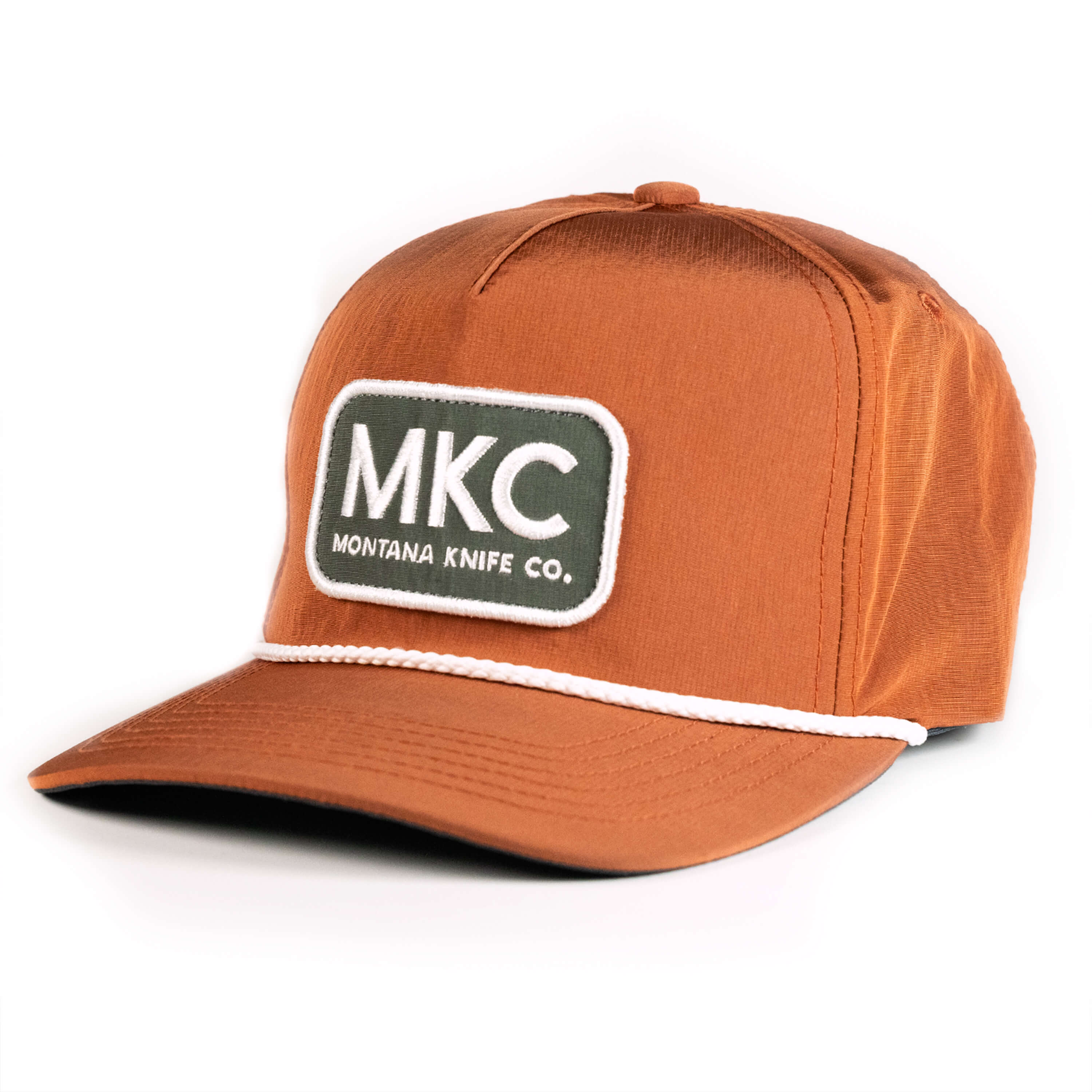 Rust-colored MKC River Rope Hat featuring a logo patch and a white rope detail on the brim. Ideal for outdoor enthusiasts.