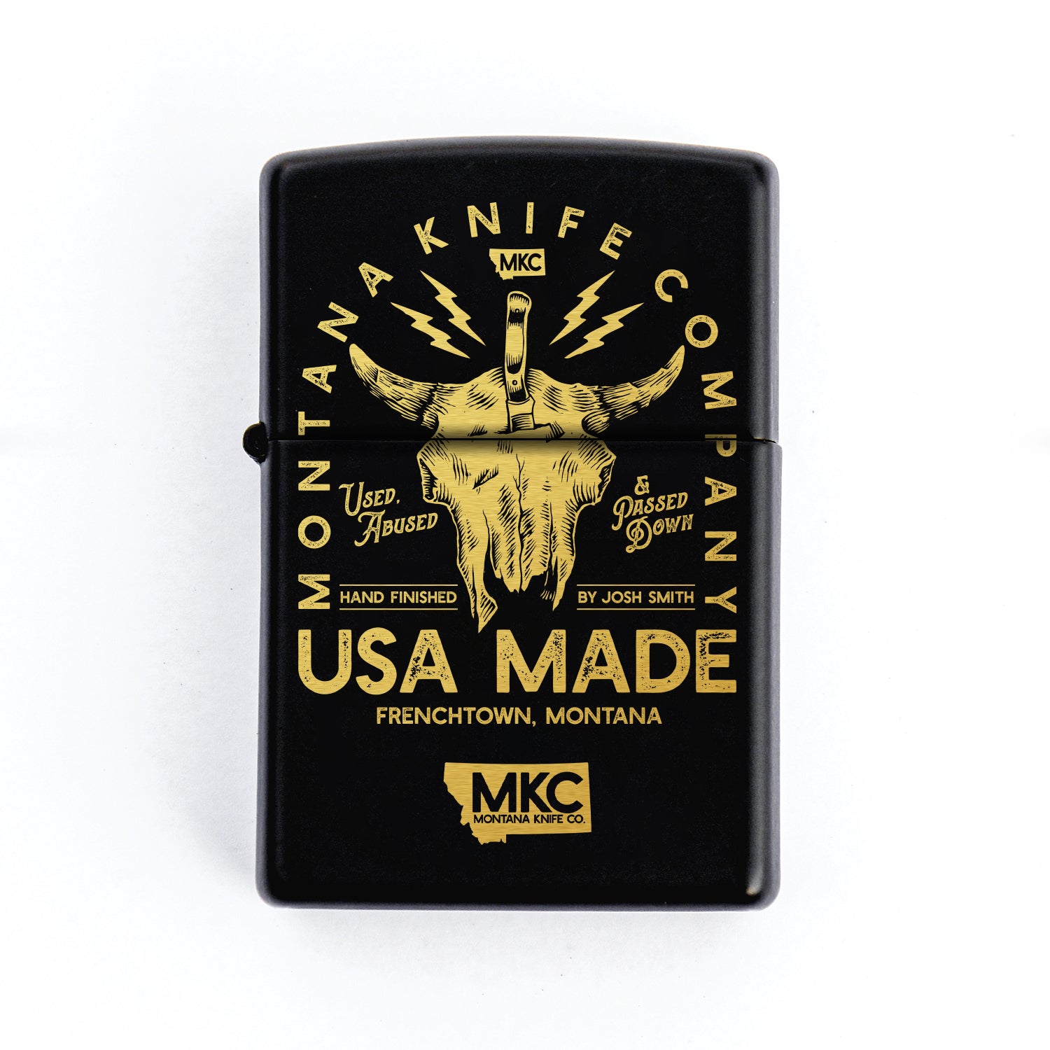 Black Zippo lighter featuring a gold bison skull design with text "Montana Knife Company - USA Made" and lightning motifs, crafted by Josh Smith in Frenchtown, Montana.