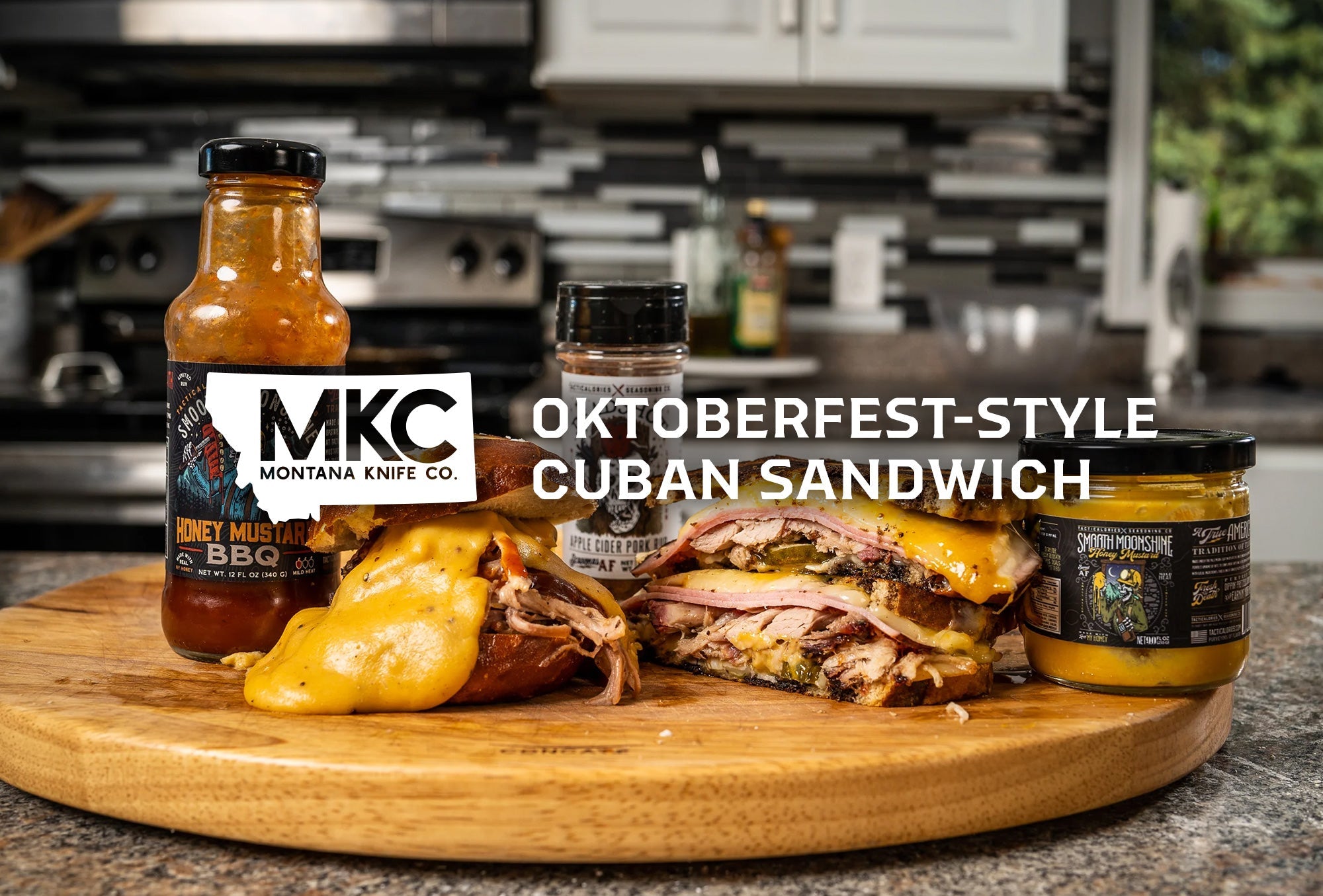 Cuban sandwich with pork, cheese, pickles, and mustard on a wood board, with Honey Mustard BBQ and Smooth Moonshine.