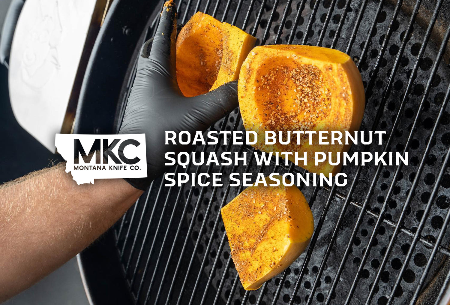 Three butternut squash slices on a grill with a gloved hand turning one for even roasting.