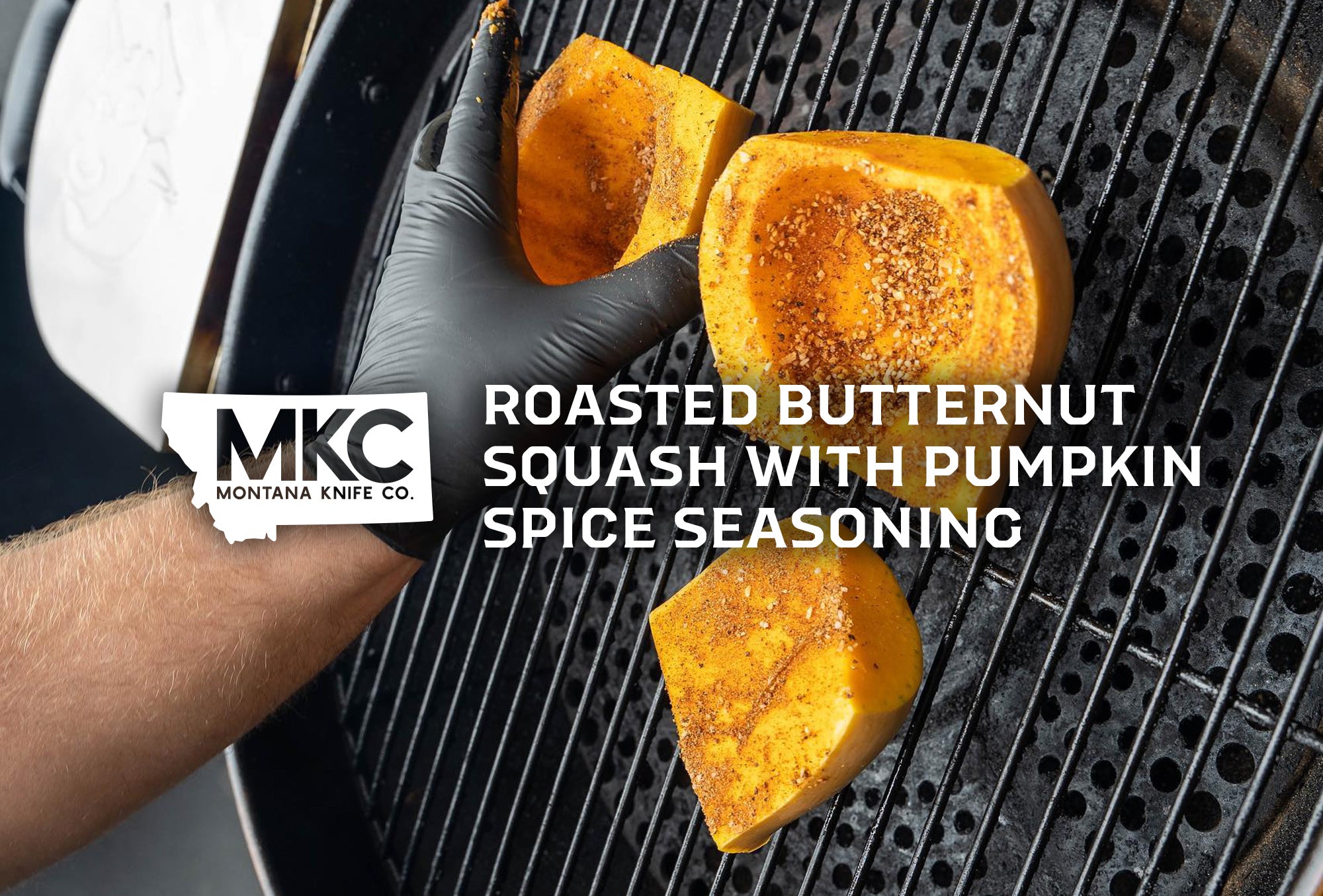 Three butternut squash slices on a grill with a gloved hand turning one for even roasting.