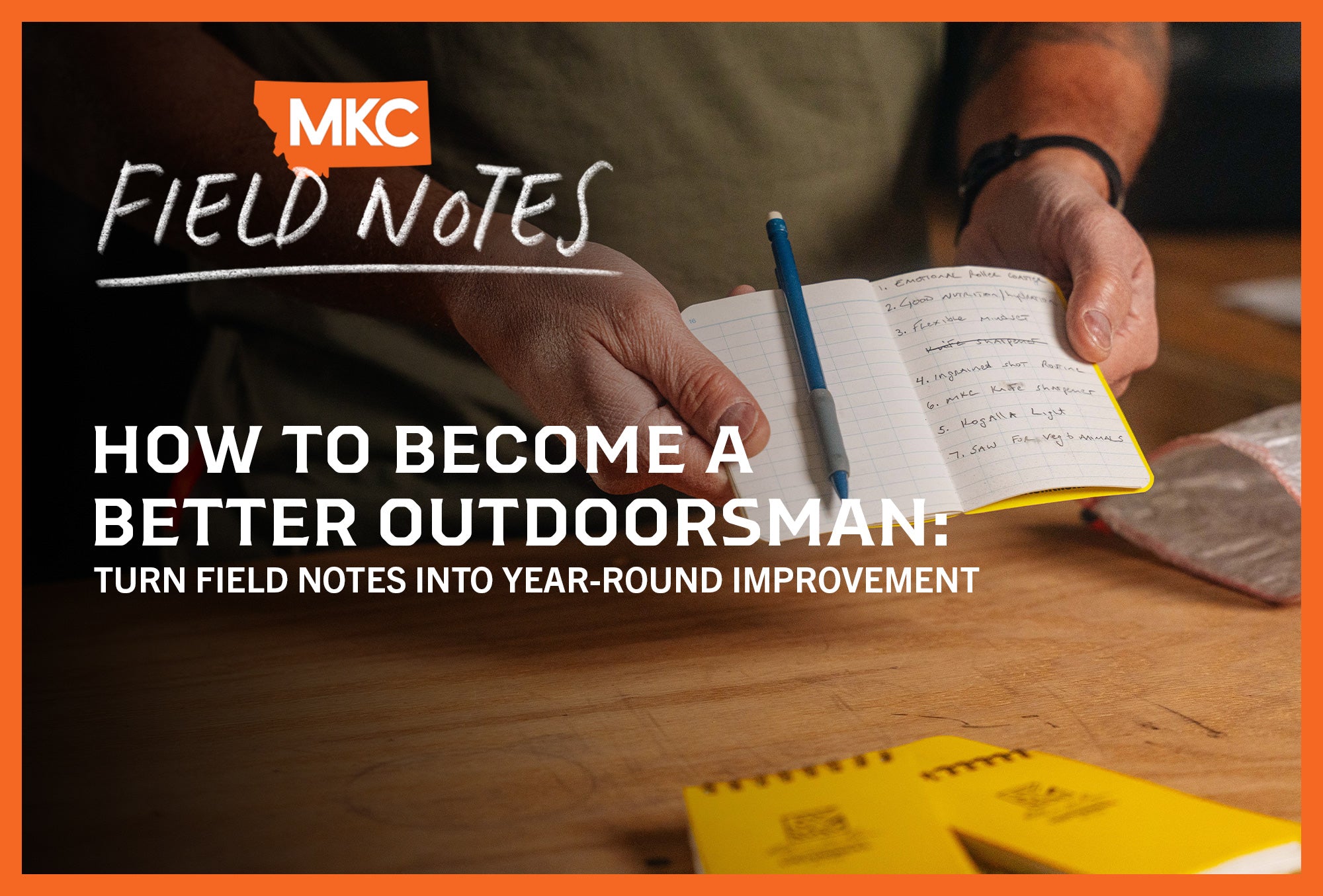 Hands holding a small notebook for recording field notes to improve backcountry skills.