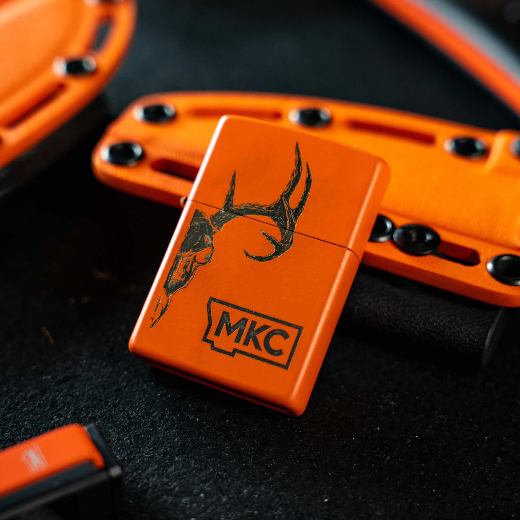 Limited edition blaze orange Zippo lighter with antler design, made in the USA, ideal for outdoor enthusiasts.