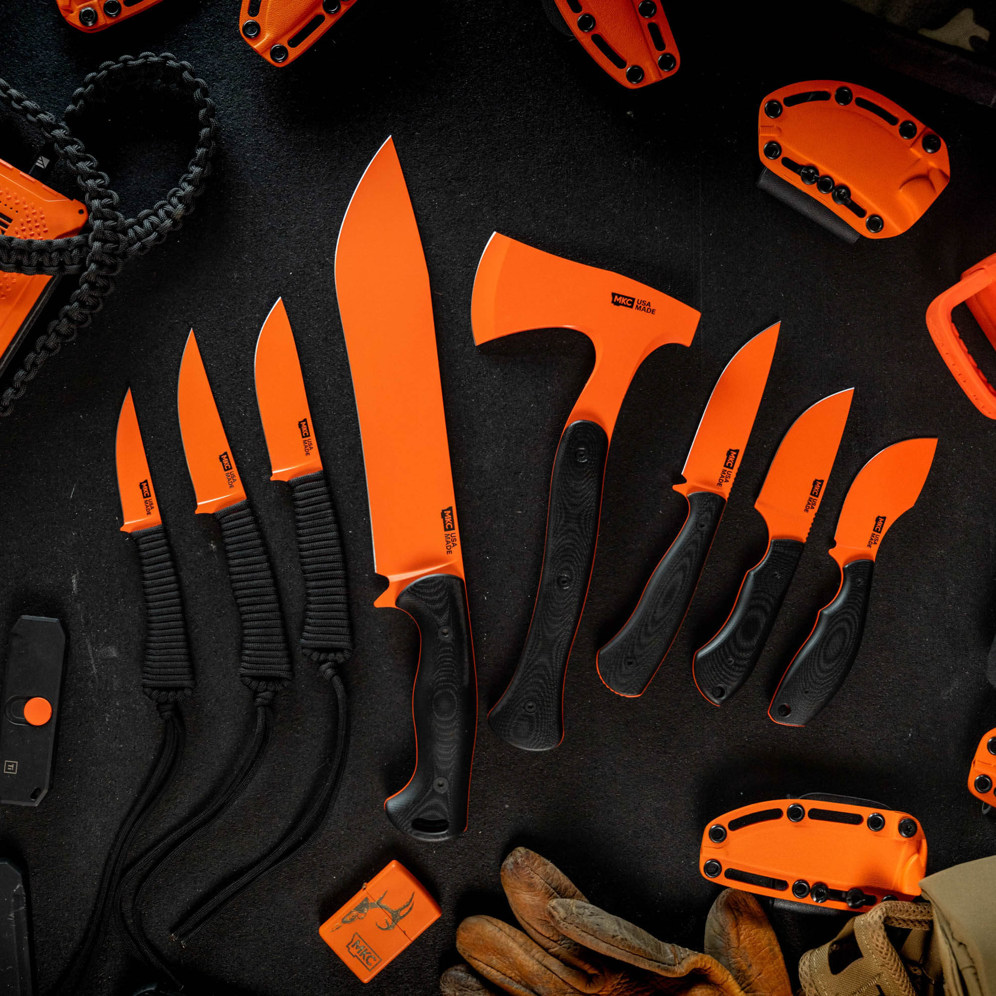 Full set of 8 knives and tools with blaze orange Cerakote finish, featuring various blade styles and grips.